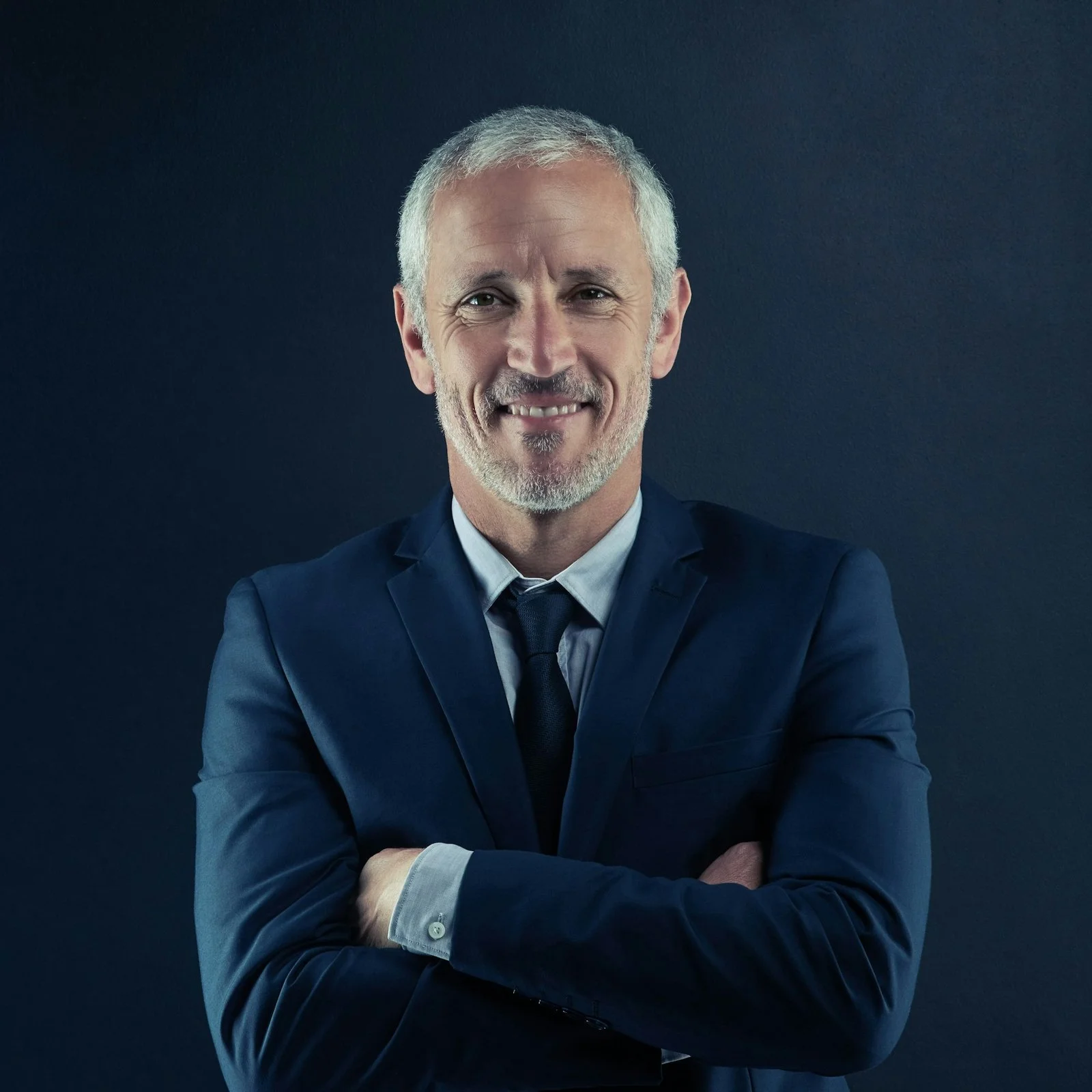 studio portrait of a mature businessman against a dark background
